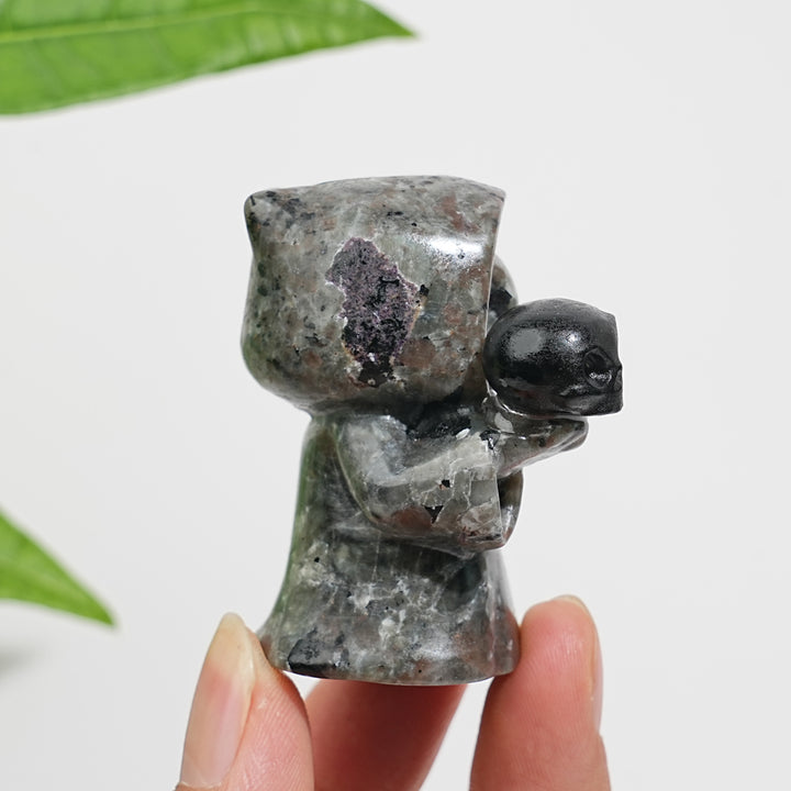 Natural Yooperlite Ghost Holding Skull Carving